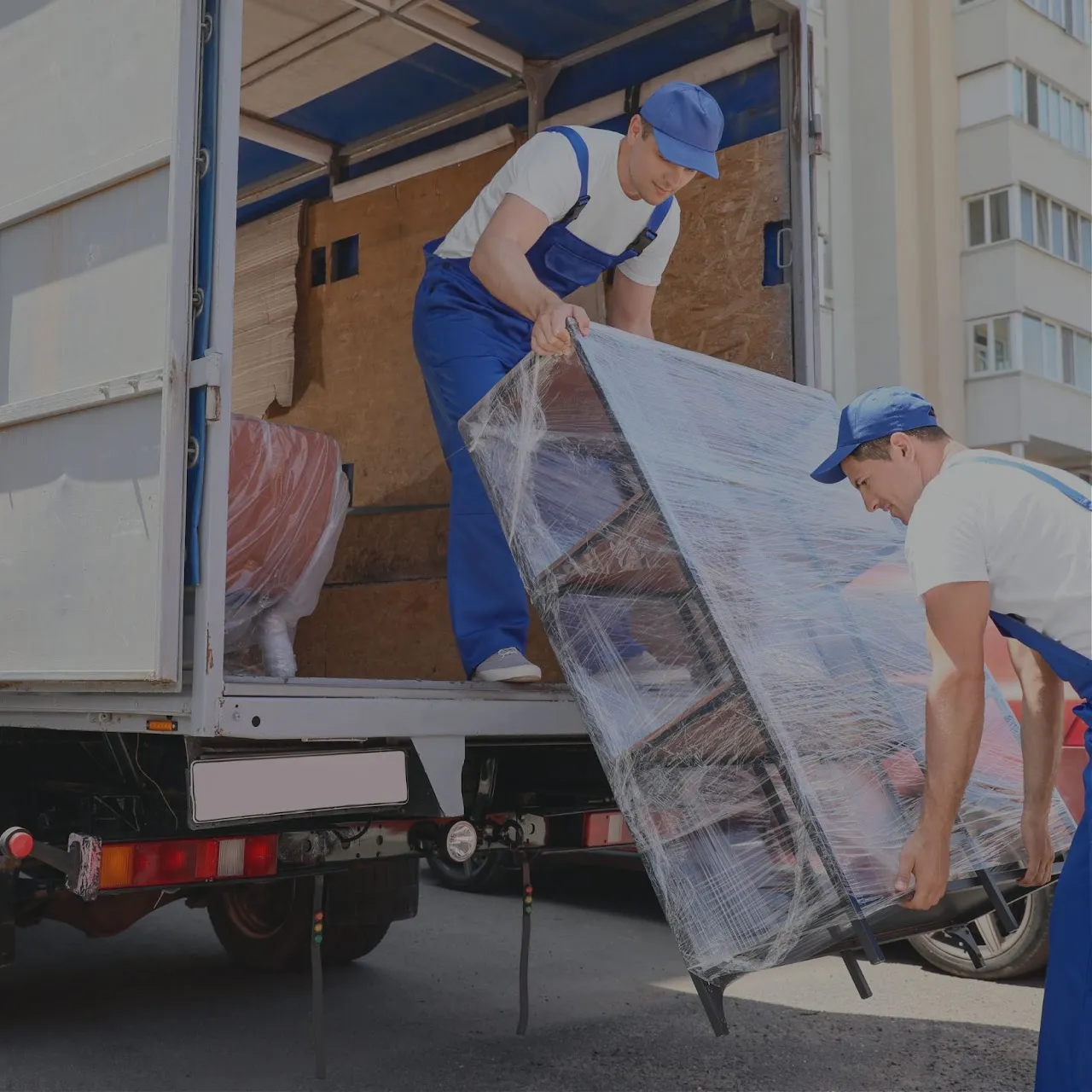 Delivery crew loading furniture into a truck